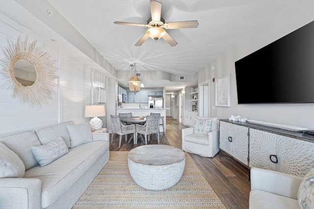 living room with ceiling fan and dark hardwood / wood-style flooring