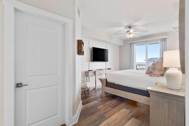 bedroom with ceiling fan and dark hardwood / wood-style flooring