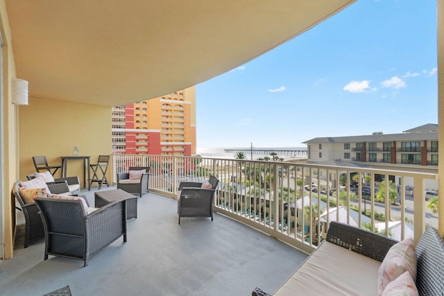 balcony featuring a water view and an outdoor hangout area