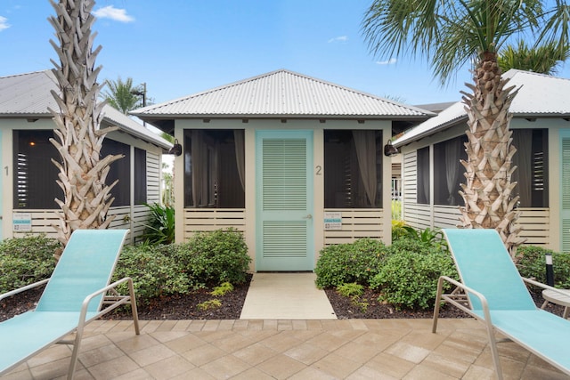 entrance to property featuring a patio area