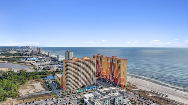 birds eye view of property with a water view and a beach view