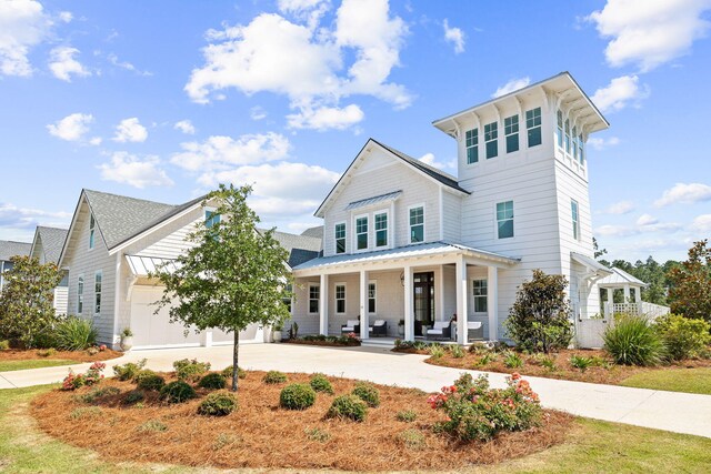 12 Needle Cast Ln, Inlet Beach, FL 32461 - view of front of property with covered porch, curved driveway, a standing seam roof, metal roof, and an attached garage