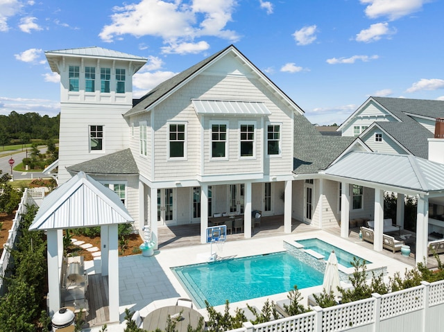 12 Needle Cast Ln, Inlet Beach, FL 32461 - rear view of house with outdoor lounge area, a fenced backyard, a patio area, and a pool with connected hot tub