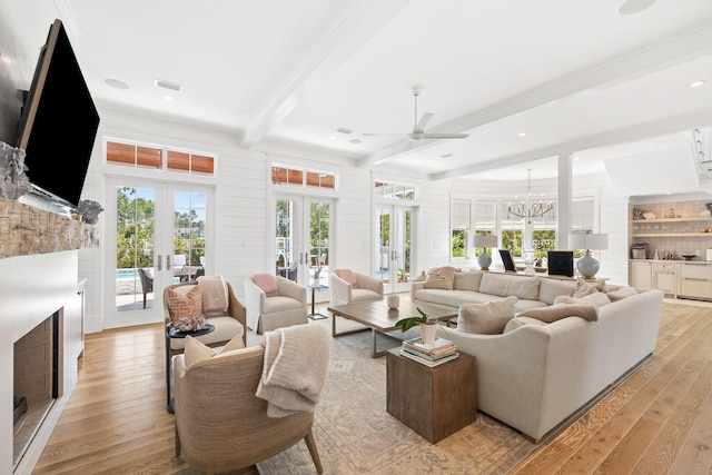 12 Needle Cast Ln, Inlet Beach, FL 32461 - living room featuring french doors, light wood-style flooring, a fireplace, beamed ceiling, and a ceiling fan