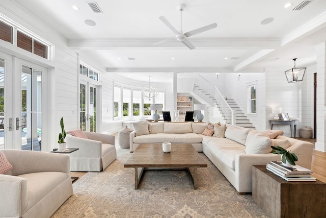 living room featuring beam ceiling, french doors, and ceiling fan with notable chandelier