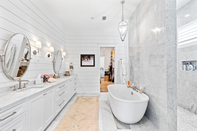 12 Needle Cast Ln, Inlet Beach, FL 32461 - full bathroom featuring a freestanding tub, double vanity, and tile walls