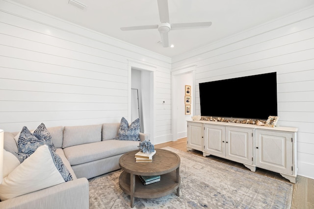 12 Needle Cast Ln, Inlet Beach, FL 32461 - living room featuring ceiling fan, wood walls, light wood-type flooring, and ornamental molding