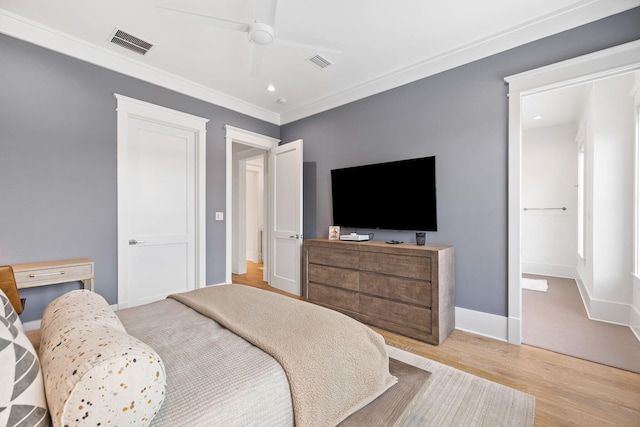 bedroom featuring light hardwood / wood-style flooring, ceiling fan, and crown molding