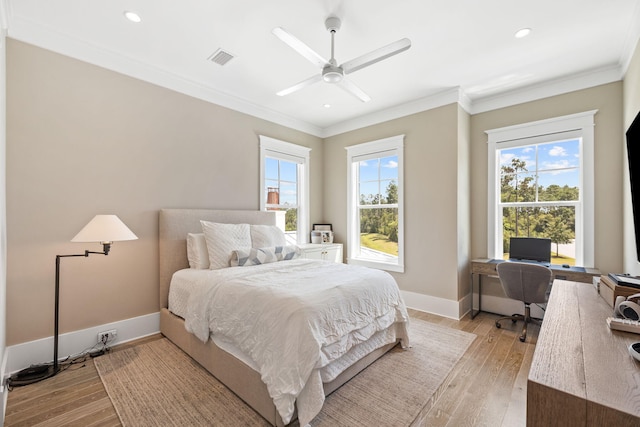 bedroom with light hardwood / wood-style flooring, ceiling fan, and crown molding