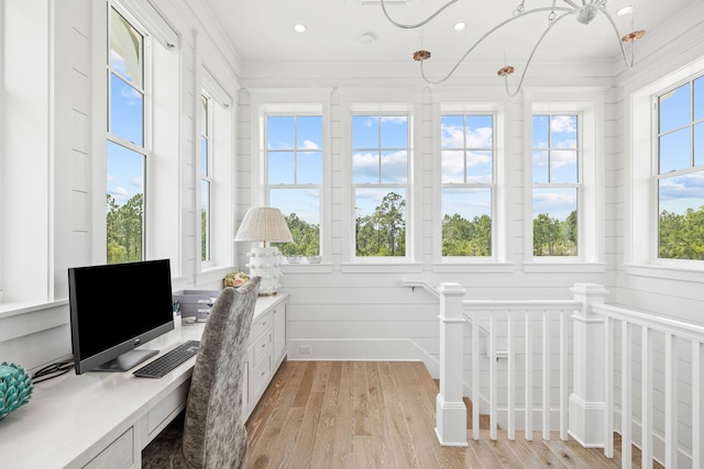 office space with light hardwood / wood-style floors and ornamental molding