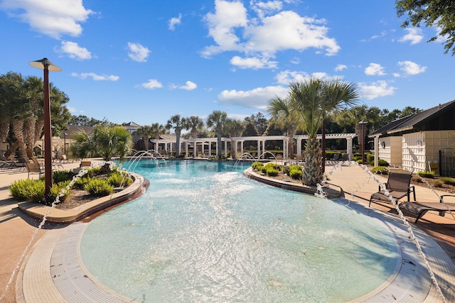 view of swimming pool featuring pool water feature and a patio