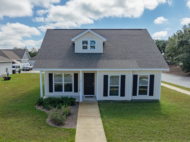 new england style home with a front lawn