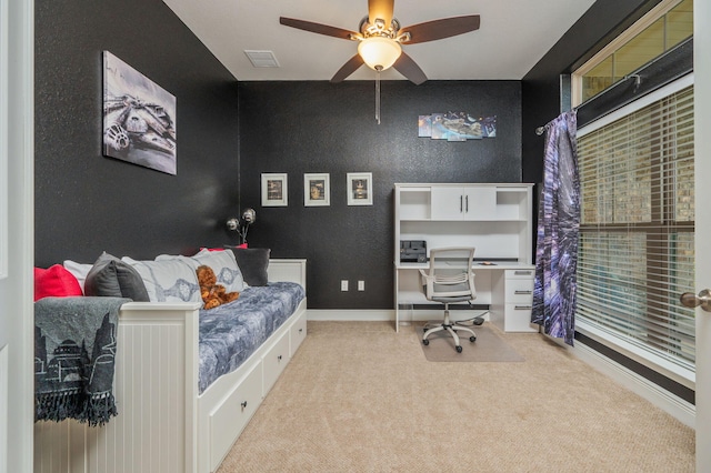 bedroom with ceiling fan and light colored carpet