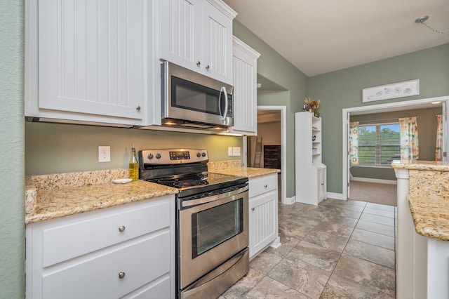 kitchen featuring light stone counters, white cabinets, and appliances with stainless steel finishes