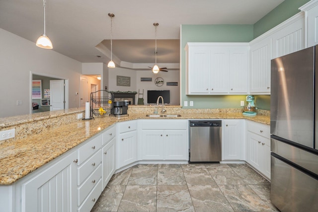 kitchen with appliances with stainless steel finishes, ceiling fan, sink, pendant lighting, and white cabinets