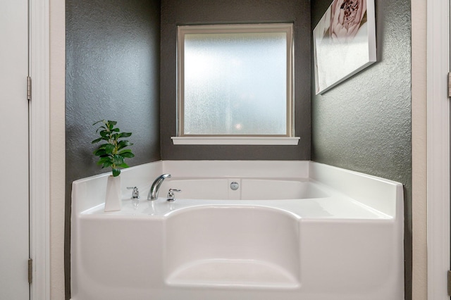 bathroom with a tub to relax in