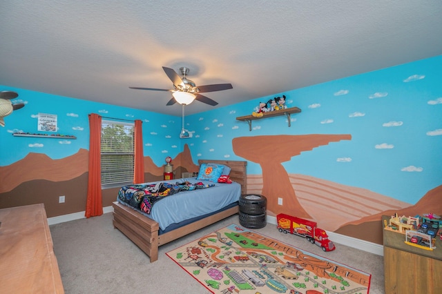 bedroom with ceiling fan, light carpet, and a textured ceiling