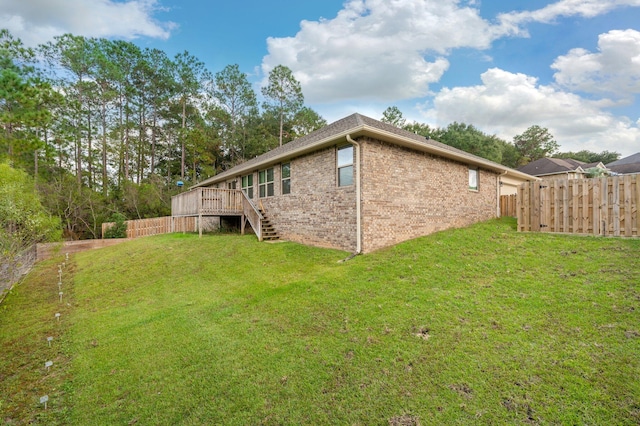 view of home's exterior featuring a yard and a deck