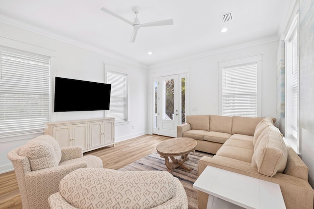 living room featuring ceiling fan, light hardwood / wood-style flooring, and ornamental molding