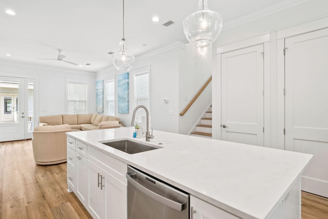 kitchen with dishwasher, white cabinets, sink, an island with sink, and decorative light fixtures