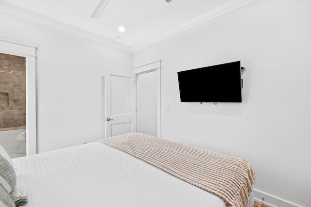 bedroom with ensuite bathroom, ceiling fan, and crown molding