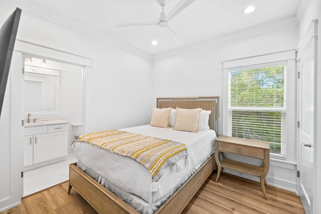 bedroom with ensuite bathroom, ceiling fan, light wood-type flooring, and crown molding