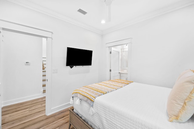 bedroom with ornamental molding, wood-type flooring, ceiling fan, and connected bathroom