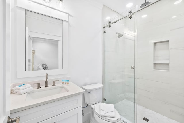 bathroom featuring walk in shower, vanity, and toilet