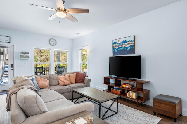 living room with ceiling fan, wood finished floors, and baseboards