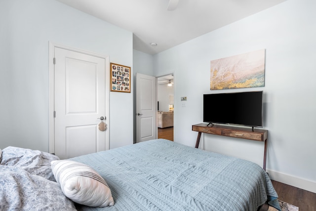 bedroom with ceiling fan and dark hardwood / wood-style floors