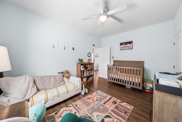 bedroom with dark wood-type flooring and a ceiling fan