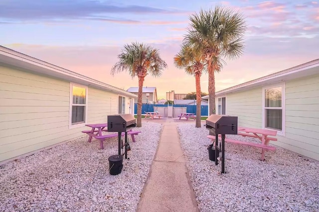 yard at dusk featuring a patio