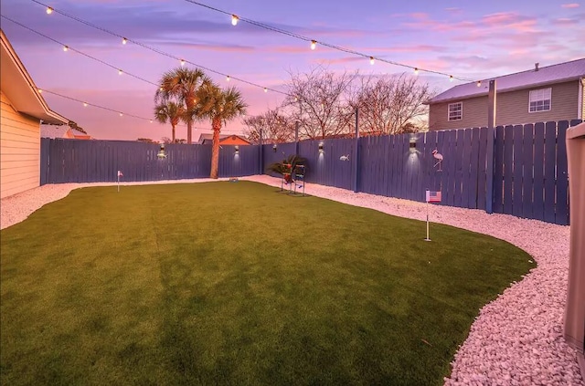 view of yard at dusk