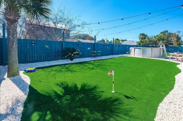 view of yard with a fenced in pool