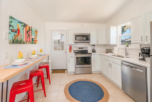 kitchen featuring white cabinets, light tile patterned flooring, sink, and stainless steel appliances