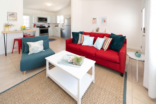 living room featuring light tile patterned floors and vaulted ceiling