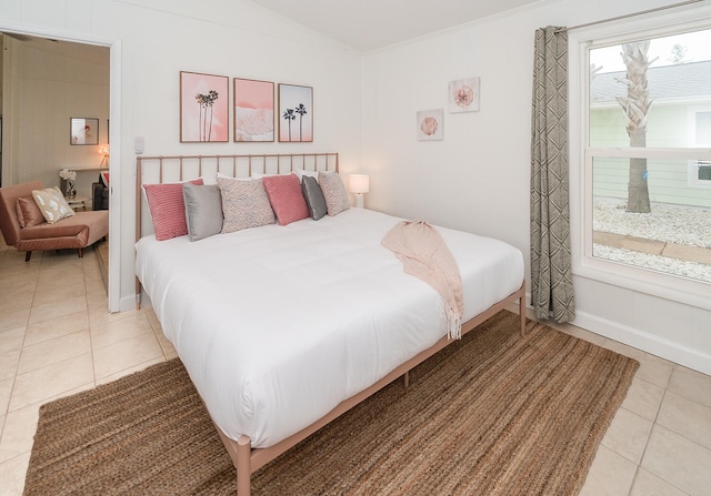 tiled bedroom featuring lofted ceiling