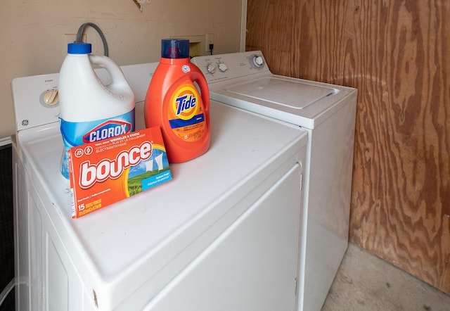 clothes washing area with separate washer and dryer