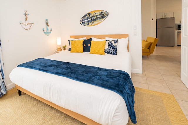 bedroom with stainless steel fridge and tile patterned floors