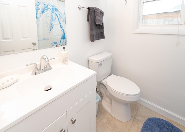 bathroom with tile patterned flooring, vanity, and toilet