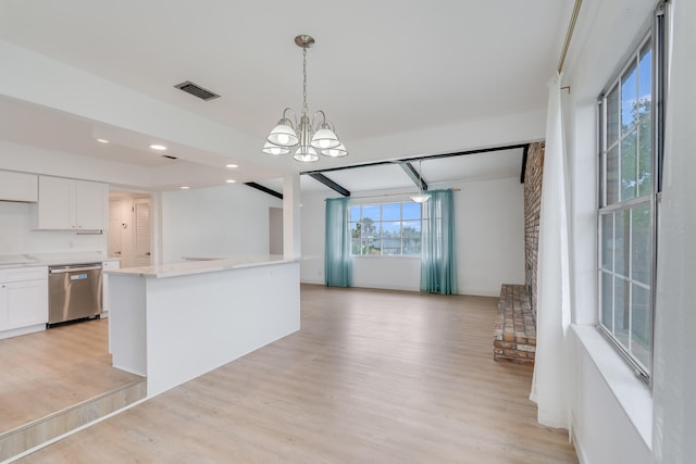 kitchen featuring a wealth of natural light, white cabinetry, stainless steel dishwasher, and light wood-type flooring