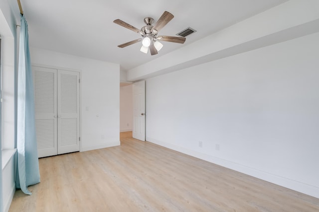 unfurnished bedroom featuring a closet, ceiling fan, and light hardwood / wood-style flooring