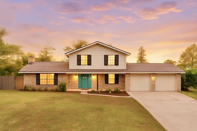 traditional-style home with a chimney, fence, a garage, driveway, and a lawn
