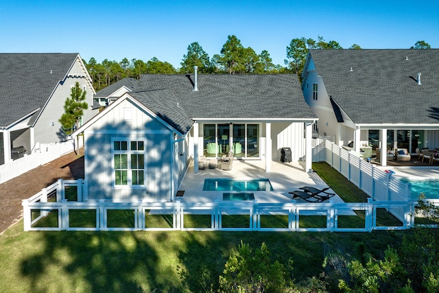 rear view of house featuring a patio, an outdoor hangout area, and a swimming pool