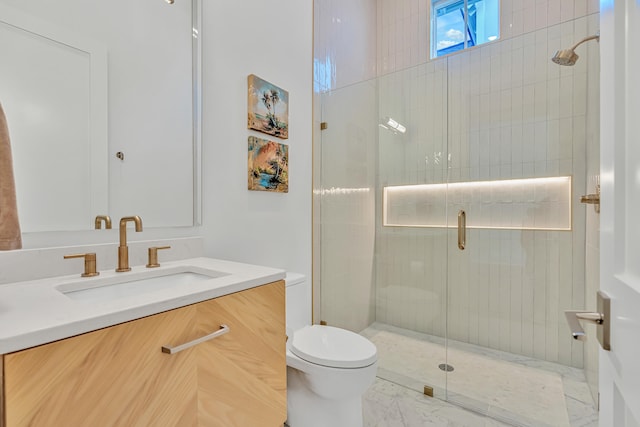 bathroom featuring toilet, vanity, and walk in shower