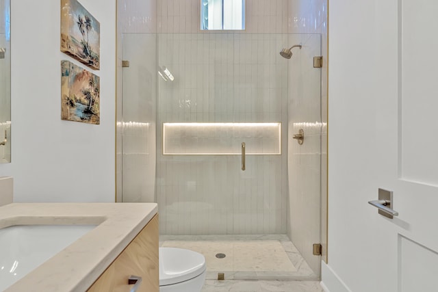 bathroom with vanity, toilet, and a shower with shower door