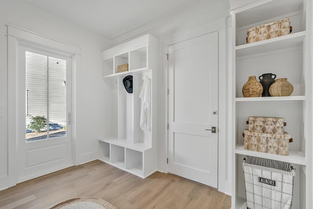 mudroom with light wood-type flooring and crown molding