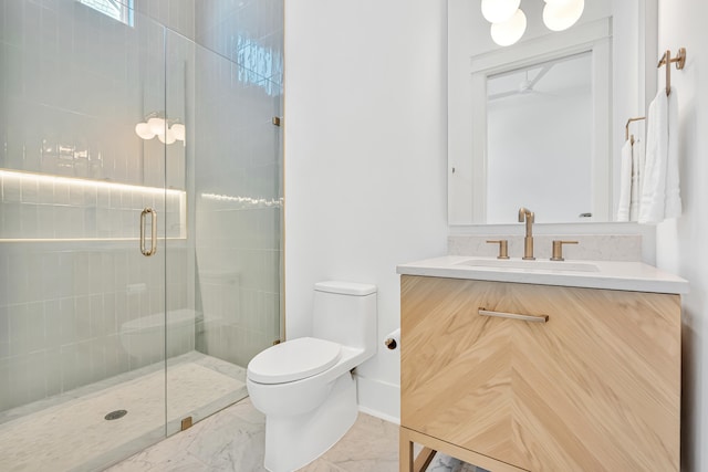 bathroom with vanity, toilet, and a shower with door