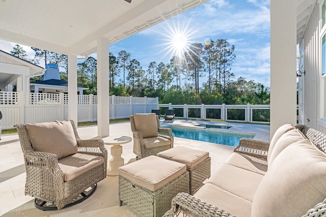 view of swimming pool featuring ceiling fan, a patio area, and an in ground hot tub