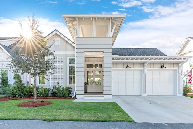 view of front of house with a front lawn and a garage